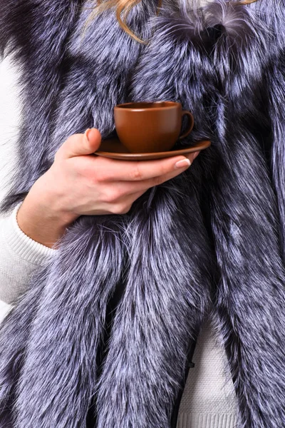 Elite coffee concept. Female hand fur coat hold brown cup or mug. Drink coffee little ceramic cup close up. Enjoy luxurious aroma and taste hot coffee. Take minute to enjoy coffee break — Stock Photo, Image