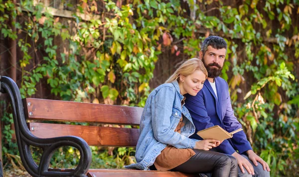 Literature common interest. How to find girlfriend with common interest. Meeting people with similar interests. Man and woman sit bench park. Read same book together. Couple interested literature — Stock Photo, Image