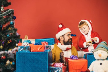 Sakallı ve mutlu yüzlü bir adam oğluyla oynuyor..