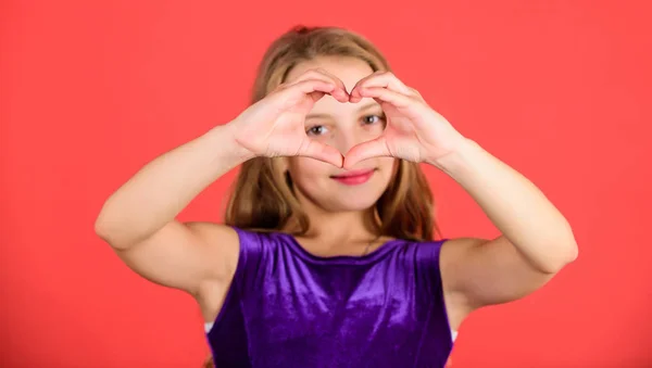 Celebrate valentines day. Love and sympathy. Love concept. Girl cute child show heart shaped hand gesture. Symbol of love. Kid adorable girl with long hair smiling face show heart gesture to you — Stock Photo, Image