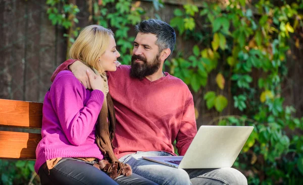 Family surfing internet for interesting content. Internet surfing concept. Couple in love notebook consume content. Surfing internet together. Couple with laptop sit bench in park nature background