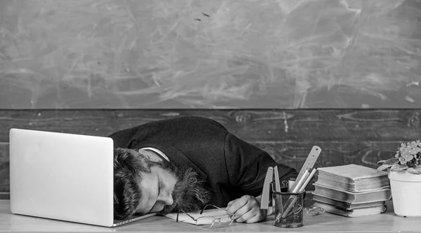 Life of teacher exhausting. Fall asleep at work. Educators more stressed work than average people. High level fatigue. Exhausting work school cause fatigue. Educator bearded man sleep table classroom