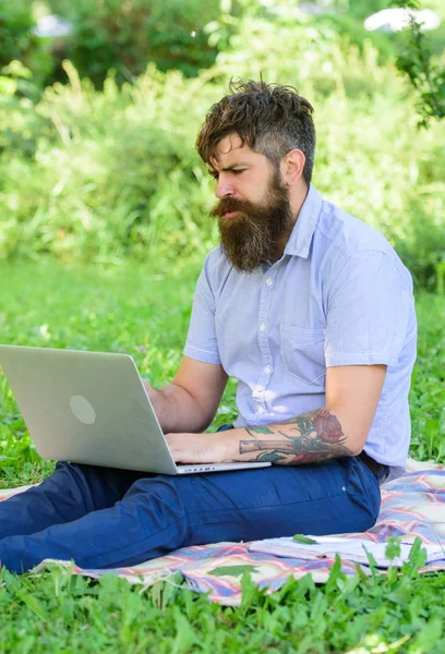 Man bearded with laptop nature background. Blogger create content for social network. Writer or blogger write post for social network. Inspiration for blogging. Blogger becoming inspired by nature