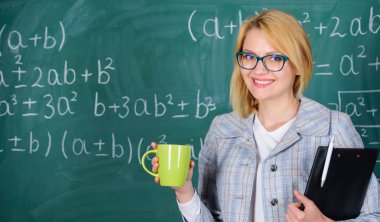 Çay fincanı ve yazı tahtası geçmişi olan bir kadın. Rahatlama zamanı. Rahatlamak ve pozitif kalmak için zaman ayır. Öğretmen çay ya da kahve iç ve pozitif kal. Olumlu düşünmeye devam et.