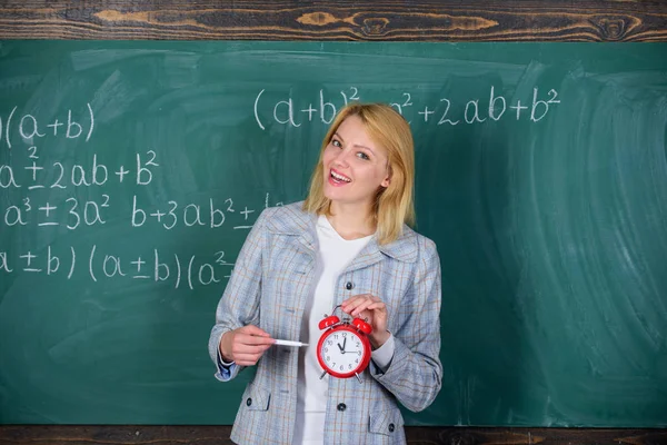 Time to study. Welcome teacher school year. Looking committed teacher complement qualified workforce educators. School discipline concept. Woman teacher hold alarm clock. She cares about discipline — Stock Photo, Image