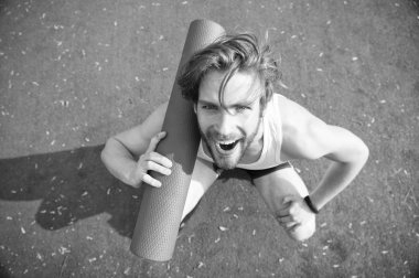 Yoga katılın. Dostum atlet neşeli gülümseyen yüz taşır, germe için gidiş mat. Sporcu açık pratik için yoga mat taşır. Açık yoga kavramı. Her zaman germe egzersiz yaptıktan sonra atlet