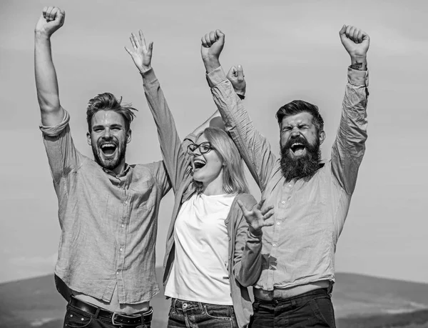 Employees enjoy feeling of freedom. Freedom concept. Company three happy colleagues office workers enjoy freedom, sky background. Men with beard in formal wear and blonde in eyeglasses finished work