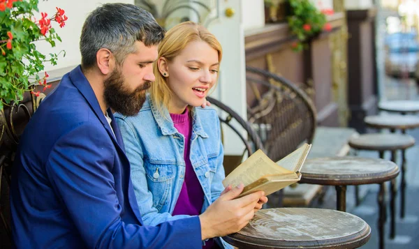 Love and flirt. Couple flirting romantic date read book. Common interests. Romantic date. Couple in love sit cafe terrace. Man with beard and blonde woman cuddle on romantic date. Romance concept — Stock Photo, Image