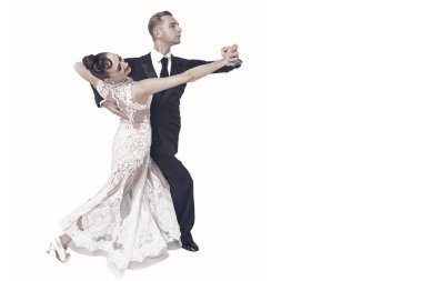 Dans eden balo çifti beyaz sahilde yalnız poz veriyor.