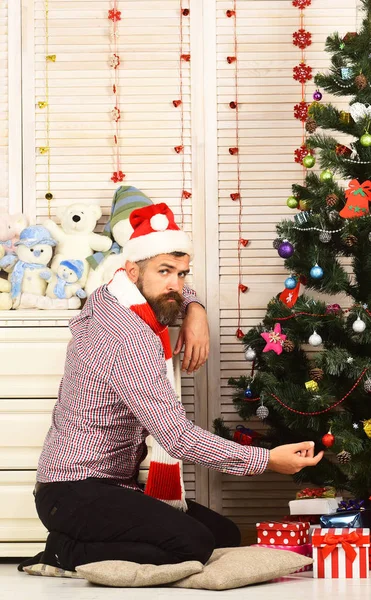 Man with beard holds Christmas ball. Celebration and decor — Stock Photo, Image