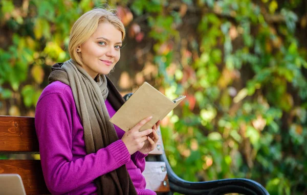 Intellectual hobby. Lady bookworm read book outdoors fall day. Girl sit bench relaxing with book fall nature background. Woman reading book. Book list for autumn season. Fall literature top list