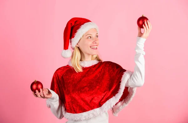 Merry christmas and happy new year. Christmas preparation concept. Lets have fun. Favorite time year christmas. Girl happy wear santa costume celebrate christmas hold ball decor pink background