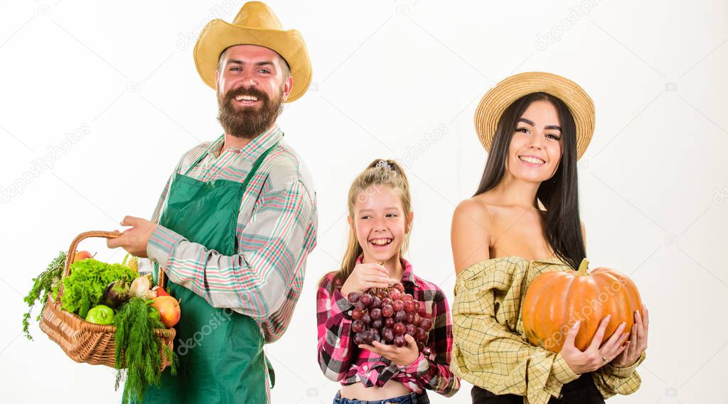 Family farmers gardeners basket harvest isolated white background. Family rustic style farmers proud of fall harvest. Harvest festival concept. Parents and daughter farmers celebrate harvest holiday