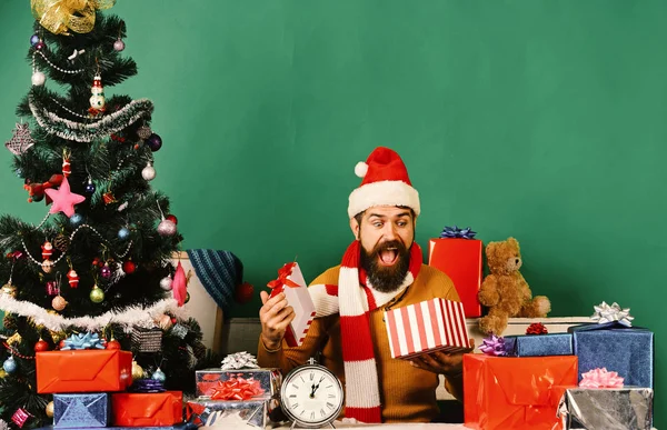 Babbo Natale apre regali vicino albero decorato — Foto Stock