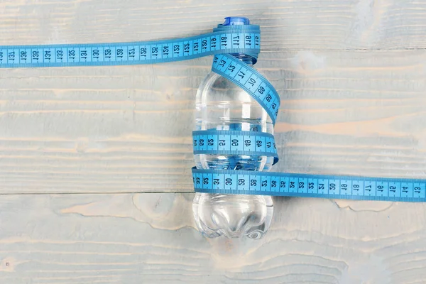 Water and measuring tape. Tools for healthy and active lifestyle