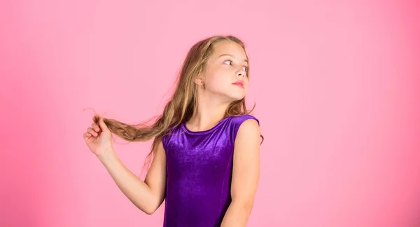 How to make tidy hairstyle for kid. Ballroom latin dance hairstyles. Kid girl with long hair wear dress on pink background. Things you need know about ballroom dance hairstyle. Hairstyle for dancer