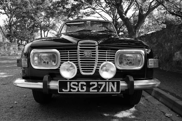 Stornoway, United Kingdom - March 19, 2010: saab car parked on street. This is good choice. Retro automobile on asphalt road under green trees. Transport and transportation. Wanderlust and travelling — Stock Photo, Image