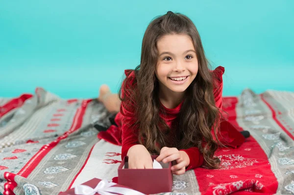 Merry Christmas and Happy Holidays. Cute little child girl with Christmas present. Happy little smiling girl open Christmas gift box. Kid enjoy Christmas holiday. Have a holly jolly xmas