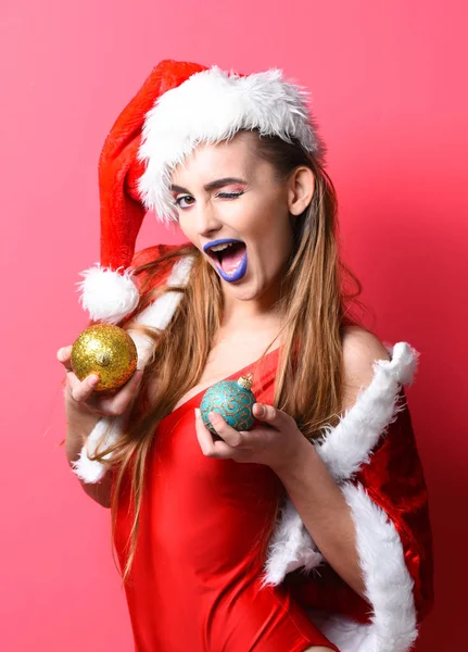 Santa κορίτσι Χριστούγεννα κόμμα μεταμφίεση. Γιορτάστε το πάρτι στην πισίνα. Κορίτσι κόκκινο μαγιό και καπέλο santa κρατήσει μπάλα Χριστουγεννιάτικη διακόσμηση. Santa κορίτσι σέξι με make up. Σάντα ελκυστική γυναίκα γιορτάζουν το νέο έτος — Φωτογραφία Αρχείου