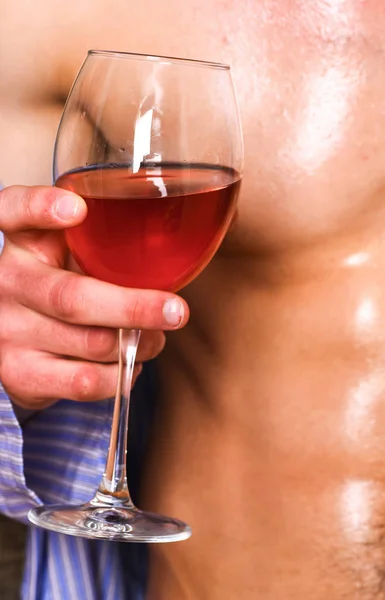 Relaxing with alcohol drink. Male sexy chest wet skin after bath wineglass. Degustate luxury wine. Drink wine and relax. Enjoy wine after bath. Pleasant relax concept. Sweaty male relax with alcohol