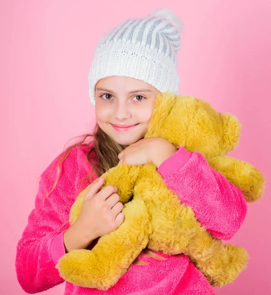 Teddy bears improve psychological wellbeing. Kid little girl play with soft toy teddy bear pink background. Unique attachments to stuffed animals. Child small girl playful hold teddy bear plush toy