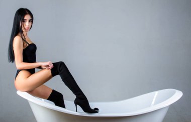 Kendine güven kavramı baştan çıkarmak için. Seksi kadın olmanın tadını çıkarın. Kız seksi poz sit küvet üzerinde rahat. Erotik ve arzu. Seksi manken küvet üzerinde poz baştan çıkarıcı. Kadın seksi kalça elbise giymek