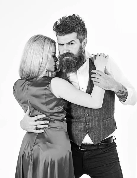 Dancing couple concept. Couple in love, dancers in elegant clothes, white background. Woman in red dress and man in vest cuddling while dancing. Bearded hipster and attractive lady at dancing contest