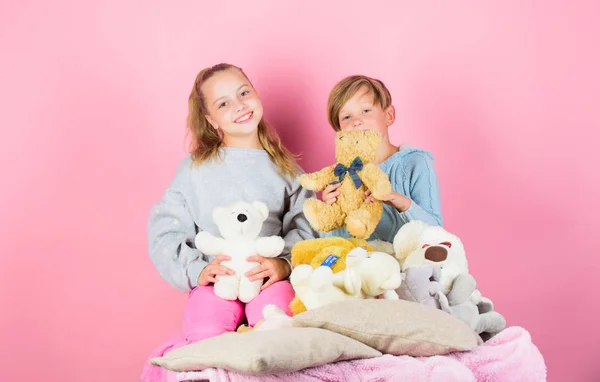 Teddy bears help children handle emotions and limit stress. Siblings playful hold teddy bear plush toys. Boy and girl play with soft toys teddy bear on pink background. Bears toys collection — Stock Photo, Image