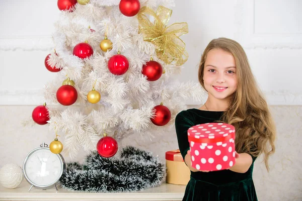 Dreams come true. Best for our kids. Kid girl near christmas tree hold gift box. Child celebrate christmas at home. Favorite day of the year. Time to open christmas gifts. Opening christmas presents