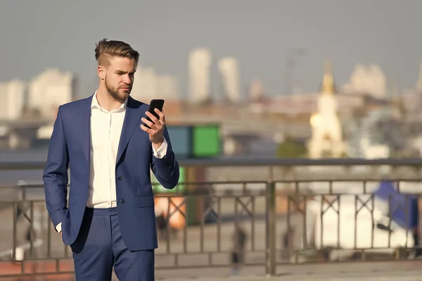 Man in formal outfit with mobile phone.