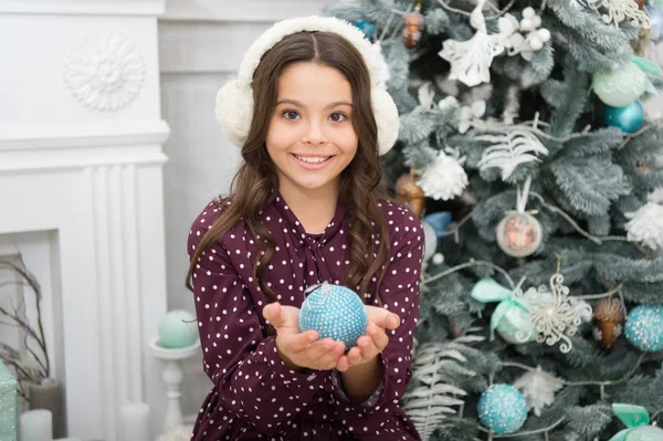 Happy new year. Christmas. Kid enjoy holiday. small happy girl at christmas. warm earphones. morning before Xmas. New year holiday. little child girl likes xmas present. Decorating tree for Christmas — Stock Photo, Image