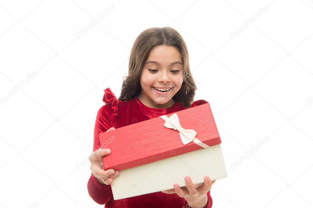 Small cute girl received holiday gift. What is inside. Best toys and christmas gifts for kids. Kid little girl in elegant dress curly hairstyle hold gift box. Child excited about unpacking her gift