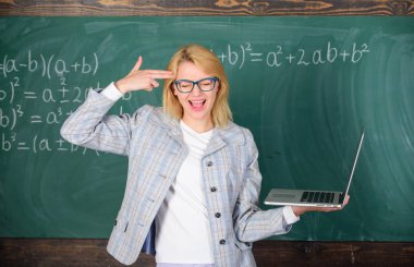Yorgun öğretmen işini tarafından rahatsız. Eğitim reformları kavramı. Yorgun veya rahatsız kadın laptop tutar. Eğitimci akıllı zeki Bayan modern dizüstü bilgisayar ile kalın silah jest onun kafa kara tahta arka plan