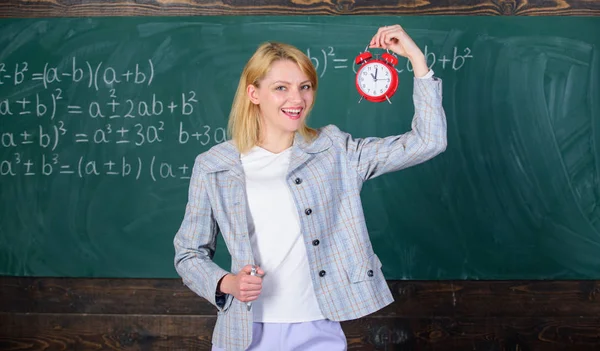 She cares about discipline. Time to study. Welcome teacher school year. Looking committed teacher complement qualified workforce educators. Always on time. Woman teacher hold alarm clock — Stock Photo, Image