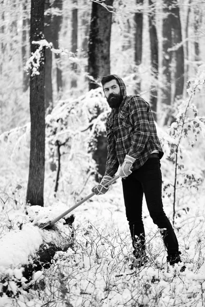 Woodsman with trees covered by snow on background.