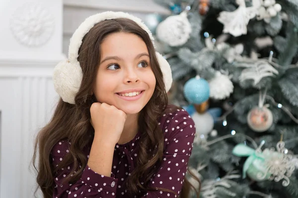 Little child girl likes xmas present. Christmas. Kid enjoy the holiday. Happy new year. small happy girl at christmas. warm earphones. The morning before Xmas. New year holiday. New year new me — Stock Photo, Image