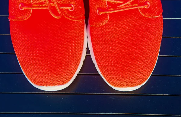 Sports shoes sneakers bright orange color. Sports in the open air. orange sport sneakers modern style. fitness and health