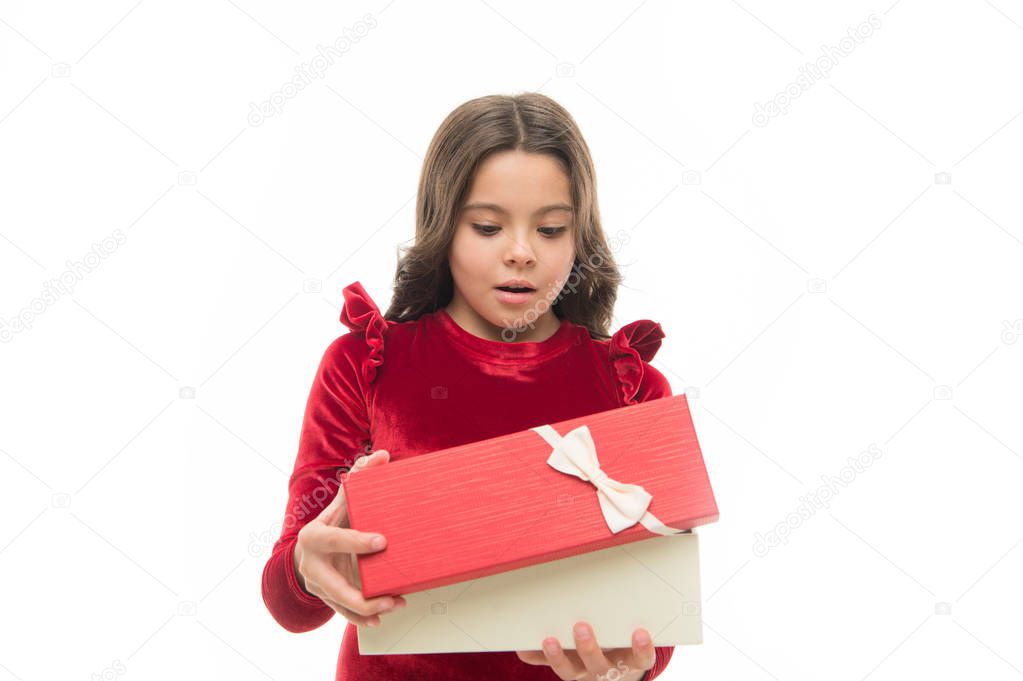 Child excited about unpacking her gift. Small cute girl received holiday gift. What is inside. Best toys and christmas gifts for kids. Kid little girl in elegant dress curly hairstyle hold gift box