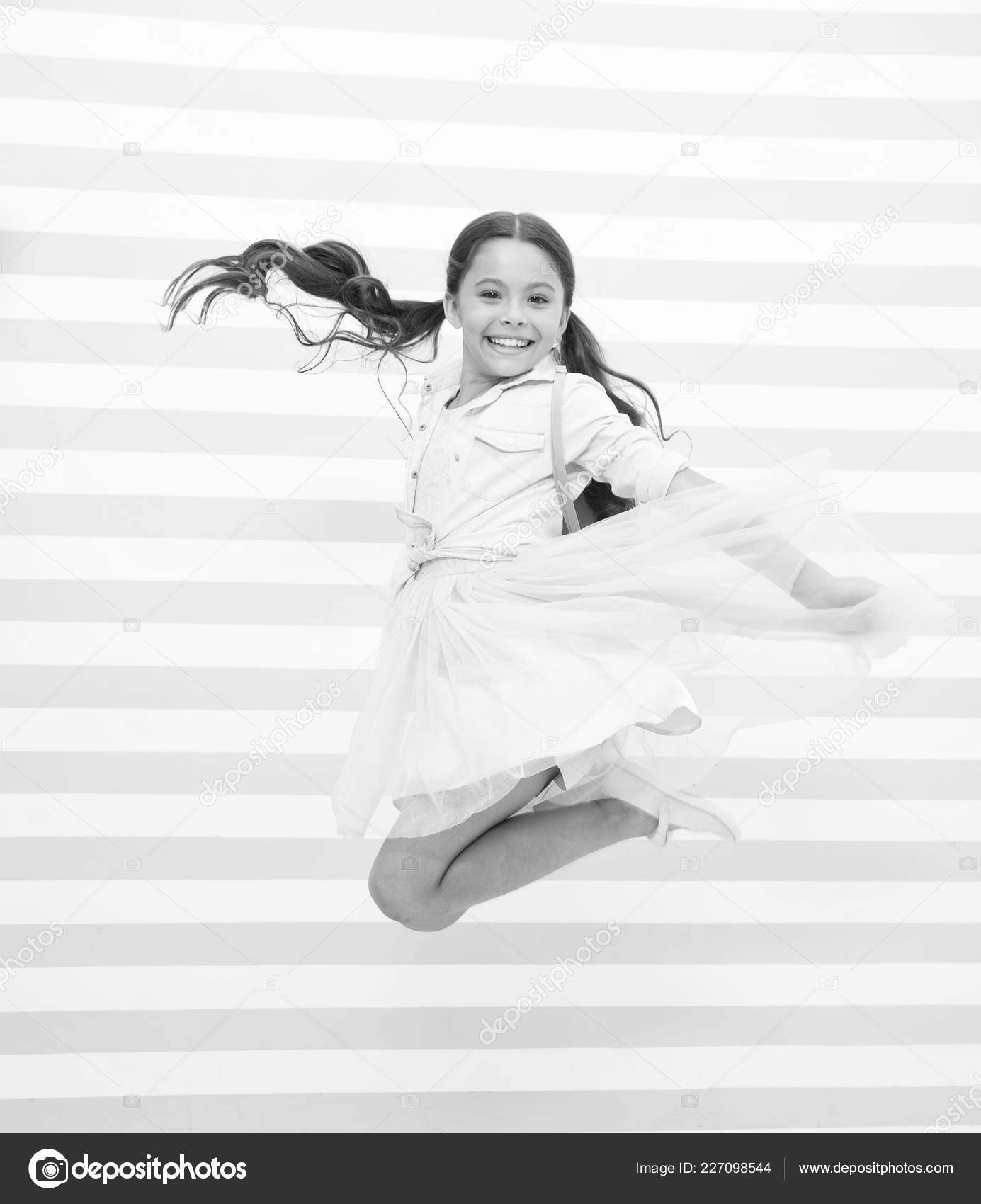 Full Of Energy Girl Happy Face Ponytail Hairstyle Jumps In Air