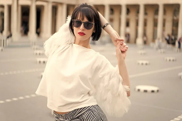 Woman hold hands behind back and stretch in paris, france