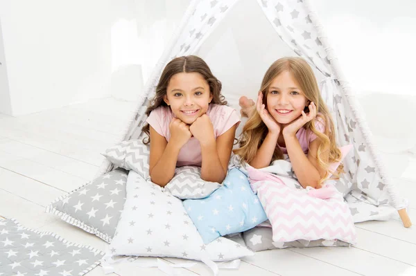 Girlish leisure. Sisters friends share gossips having fun at home. Pajamas party for kids. Siblings best friends. Sisters or best friends spend time together in bedroom. Girls having fun together