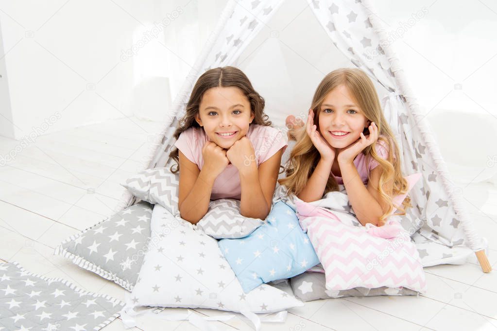 Girlish leisure. Sisters friends share gossips having fun at home. Pajamas party for kids. Siblings best friends. Sisters or best friends spend time together in bedroom. Girls having fun together