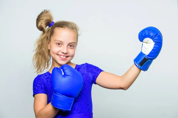 little girl in boxing gloves punching. Sport and sportswear fashion. knockout and energy. Sport success. training with coach. Fight. Boxer child workout, healthy fitness. Training his boxing skills