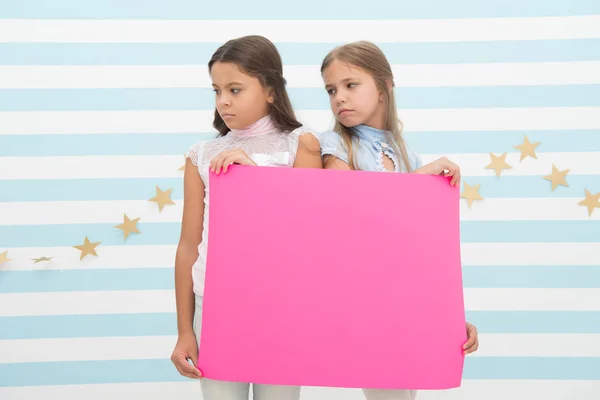 Sajnálattal tájékoztatom. Lányok tarts reklám plakát másol. Gyermekek tartani reklám banner. Szomorú gyerekek üres papír hirdetés. Reklám fogalma. A reklám jó kezekben — Stock Fotó