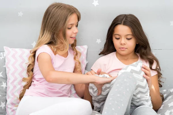 Doing whatever they want. Girls sleepover party ideas. Soulmates girls having fun sleepover party. Girls happy friends with cute pillows. Pillow fight pajama party. Sleepover time for pillow fight — Stock Photo, Image