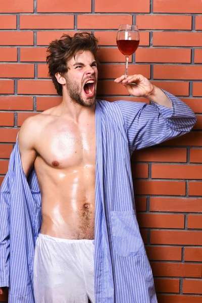 Drink wine and relax. Erotic and desire concept. Man sexy chest sweaty skin hold wineglass. Guy attractive relaxing with alcohol drink. Bachelor enjoy wine. Macho tousled hair degustate luxury wine