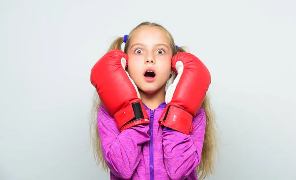 Boxer child workout, healthy fitness. knockout and energy. Sport success. Sport and sportswear fashion. little girl in boxing gloves punching. training with coach. Fight. watching score