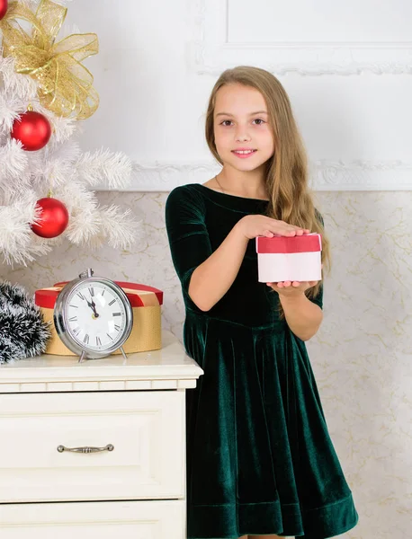 Time to open christmas gifts. Merry christmas concept. Dreams come true. Best for our kids. Child celebrate christmas at home. Favorite day of the year. Kid girl near christmas tree hold gift box