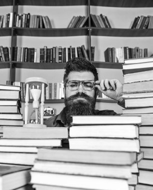 Zaman akışı kavramı. Öğretmen ya da sakal Kitaplığı'nda eğitim ile öğrenci. Dostum, bilim adamı bardaklarda kum saati görünüyor. Adam ciddi yüz izlerken zaman raflardan, arka planda gidiyor