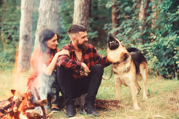 Couple in love, young happy family spend leisure with dog.